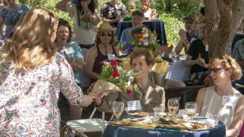 Poppy receiving thank you flowers from the SLLC community