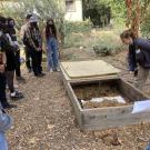 Lead Student Farmer Allison showing the tour group the Eco Garden compost