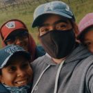 selfie of green fellow gabriela fontanesi and four of her co-workers on the Mathiasson vineyard, in hats and masks, smiling